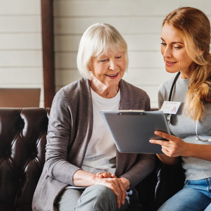 front-view-shot-of-caring-young-woman-nurse-help-old-granny-during-homecare-medical-visit.jpg